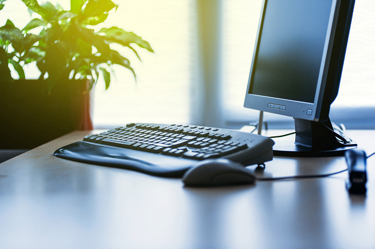 Modern-Computer-on-desk-in-office-lit-by-sun